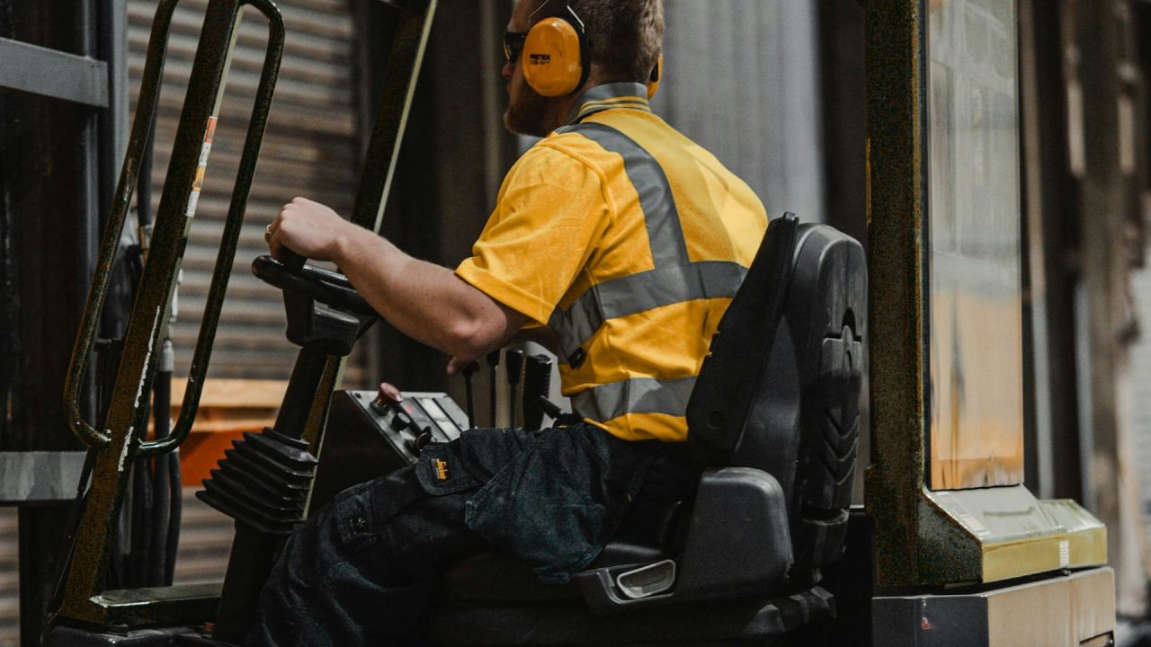 Forklift handling wood products in a warehouse