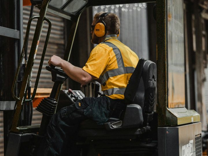 Forklift handling wood products in a warehouse